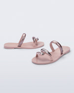 Side and angled view of a pair of pink Eden sandals with metallic straps