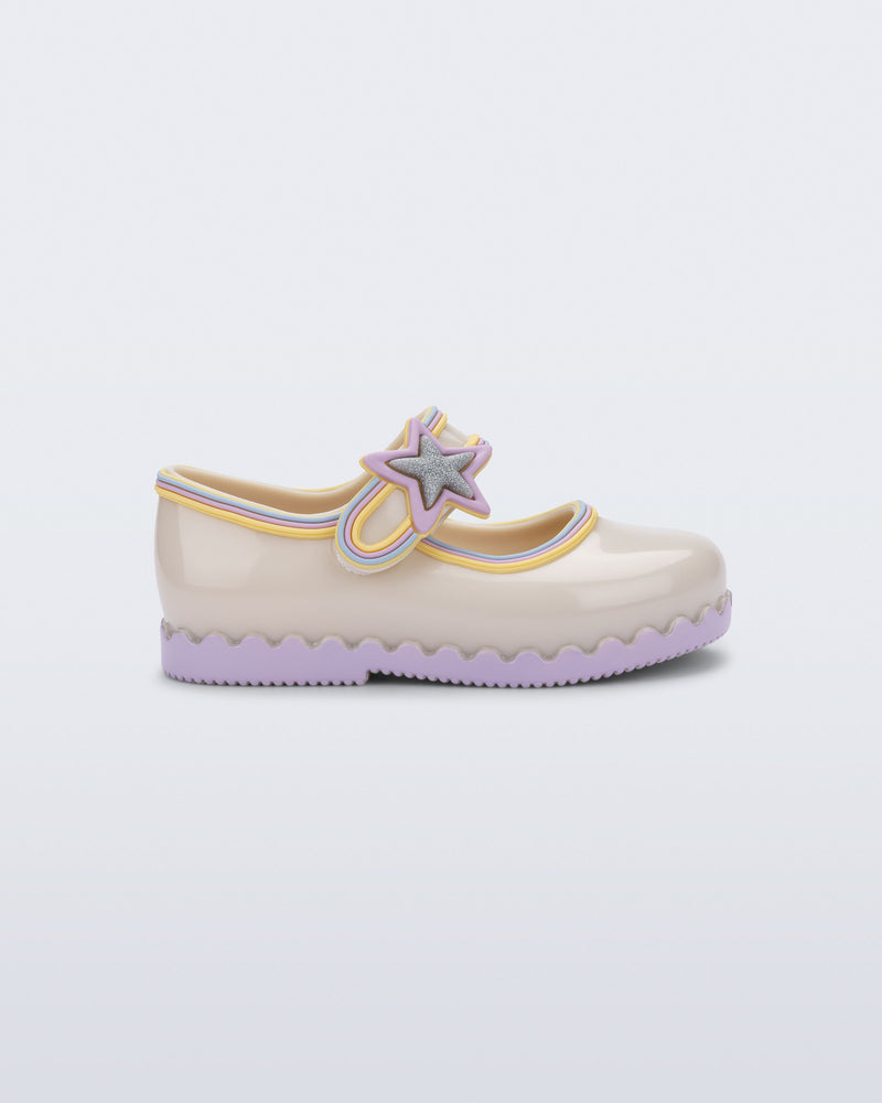Side view of a beige Hip Ballerina Star baby Mary Jane shoe with lavender soles and star-shaped strap