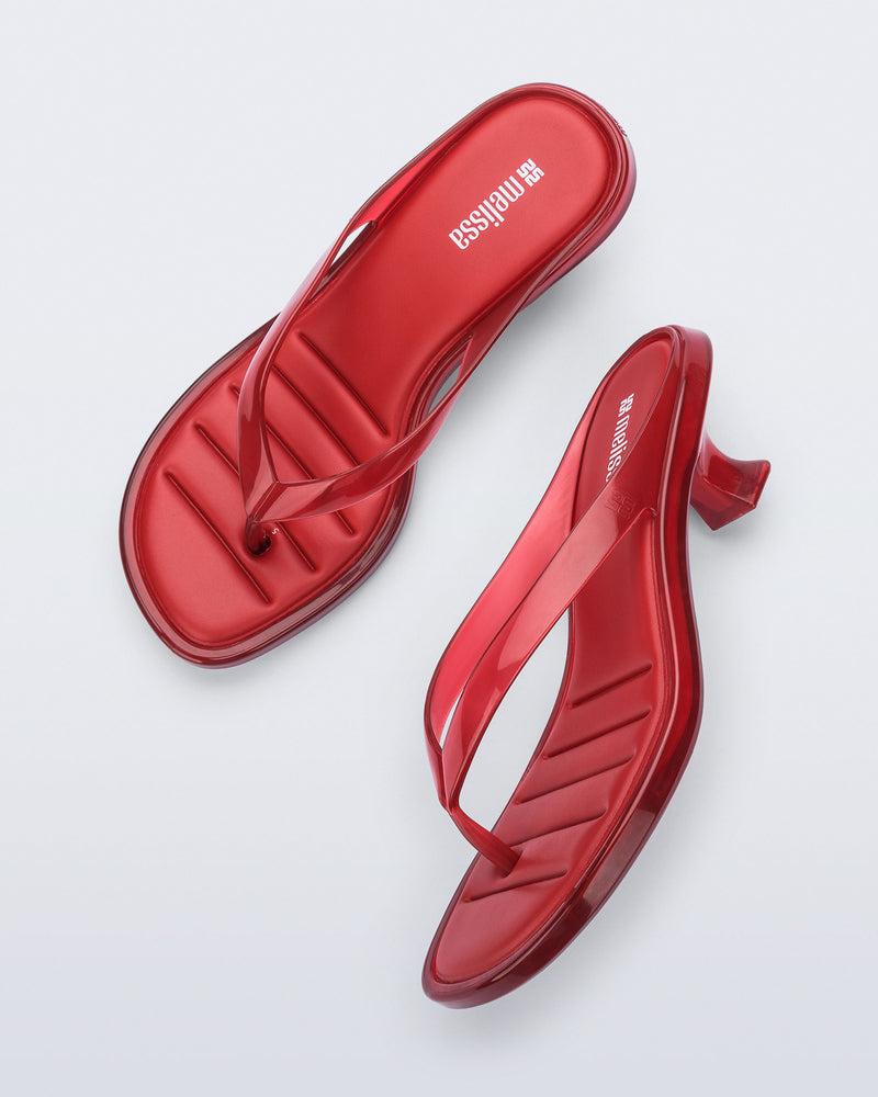 Top and side view of a pair of transparent red Flip Flop Kitten Heels