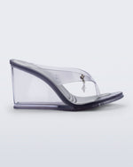 Side view of a clear grey Nabeela wedge flip flop with star charm on the strap