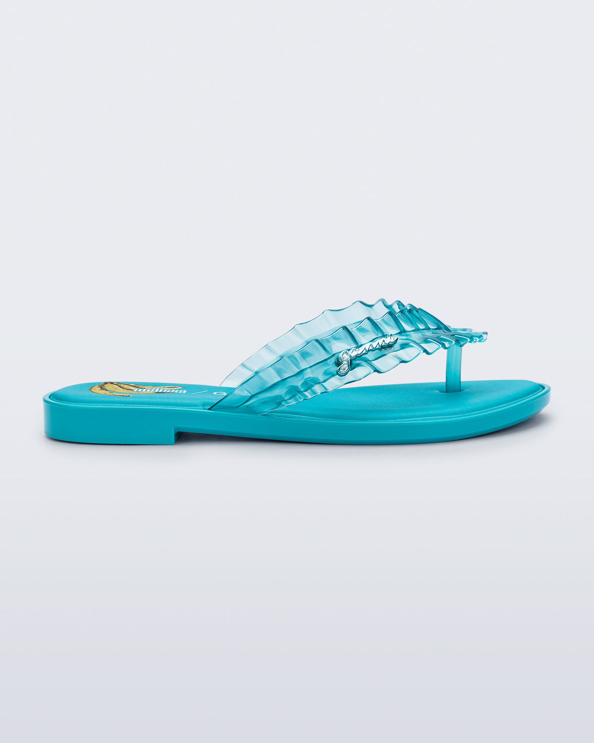 Side view of a blue Flip Flop Slim + GANNI sandals with a banana print foot bed and faux ruffle strap