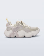 Side view of a Beige Melissa X Rush sneaker