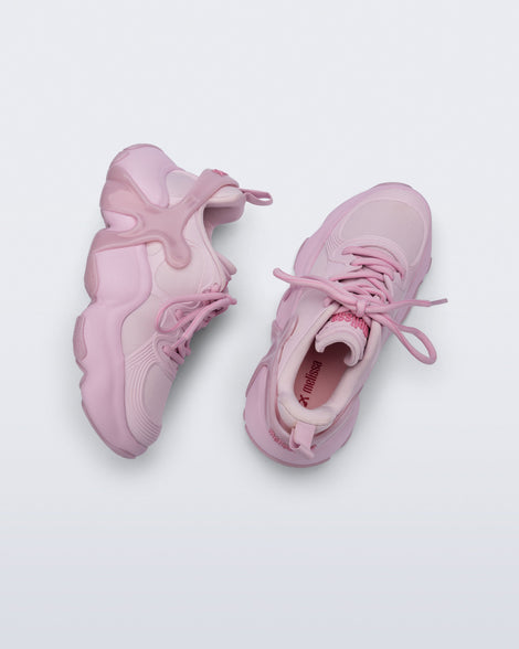 Top and side view of a pair of pink Melissa X Rush sneakers