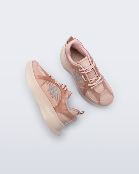 Side and top view of a pair of pink Melissa X Beat sneakers on a light gray background