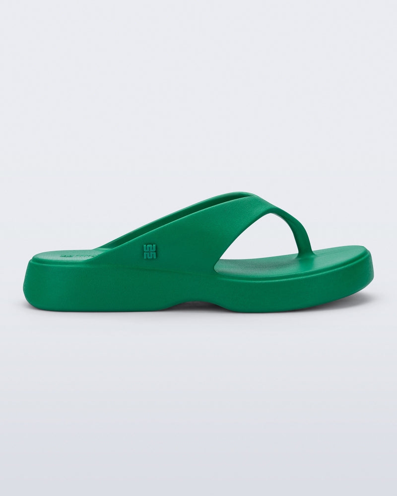 Side view of a green Free Thong Low flip flop