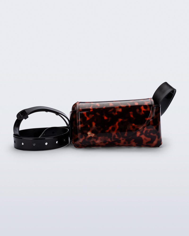 Front view of a tortoise Cross Bag with adjustable black strap