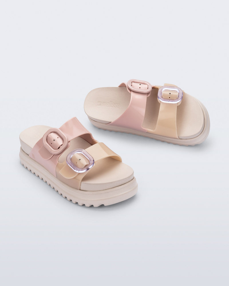 Top and angled view of a pair of beige/pink Cozy Platform slide sandals with two buckle straps.