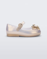 Side view of a pearly gold Mini Melissa Sweet Love Butterfly flat with a top strap and a gold butterfly detail on the toe