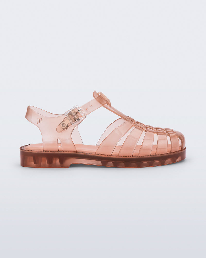 Side view of a transparent beige/pink Possession kids sandal