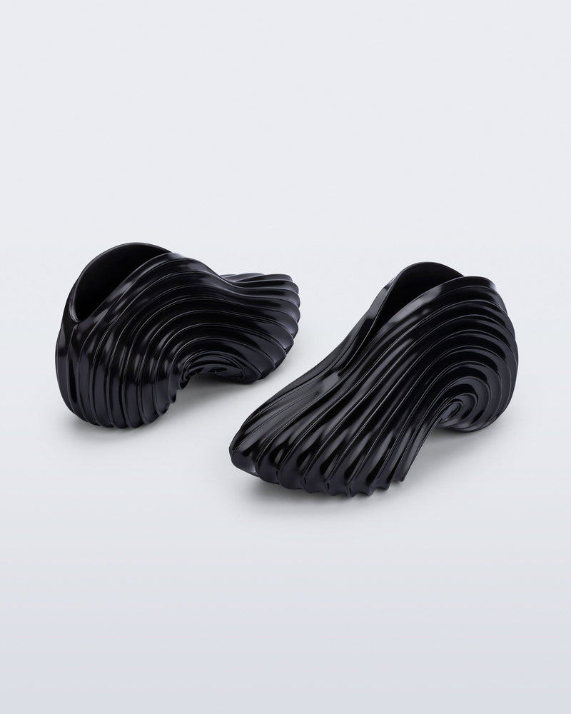 Back and angled view of a black Sneaker + Diesel
