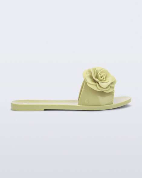 Side view of a green Babe Petals slide sandal