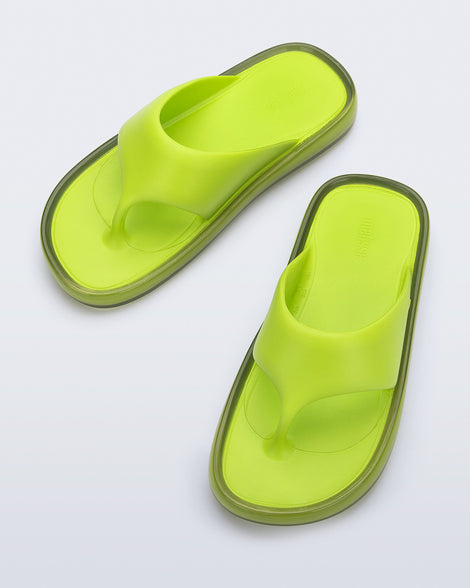 Top view of a pair of green Float flip flops