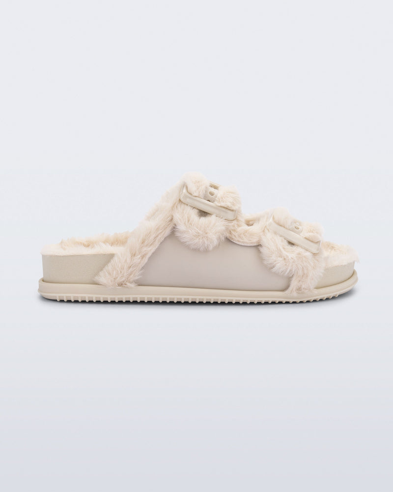Side view of an beige Cozy Warm Slide with beige fuzzy insole