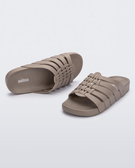 Top and angled view of a pair of beige Possession Slide