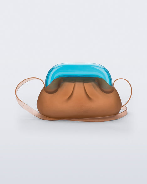 Back view of a small clear orange bag with blue clutch and long strap
