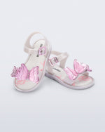 Angled view of a pair of pearly white baby Butterfly sandals with pink butterflies