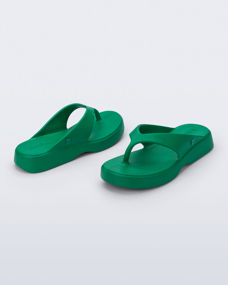Angled view of a pair of green Free Thong Low Flip Flops