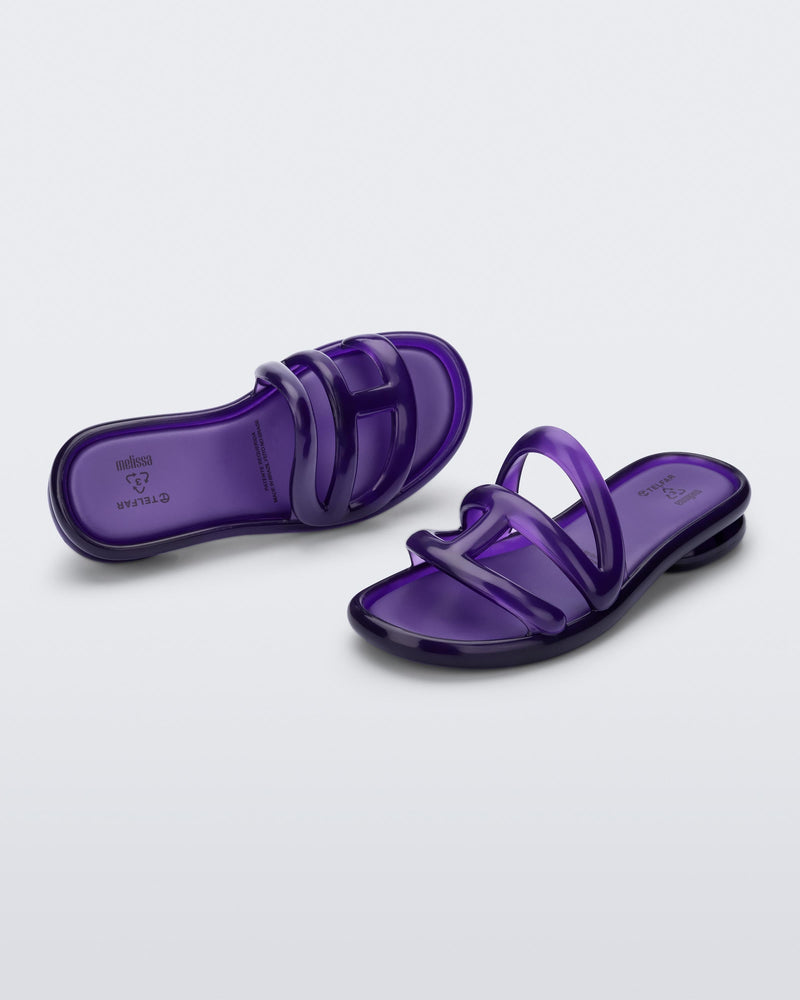 Angled view of a pair of purple Jelly Slide x Telfar.