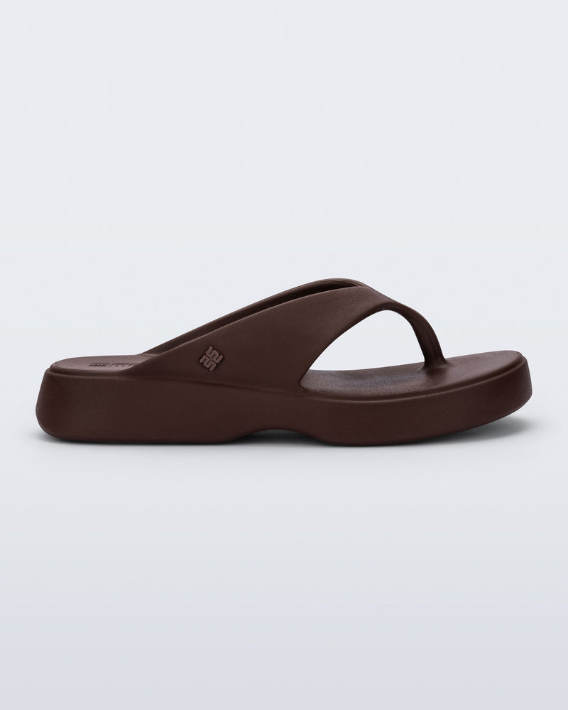 Side view of a bronze Free Thong Low flip flop