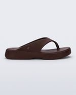 Side view of a bronze Free Thong Low flip flop