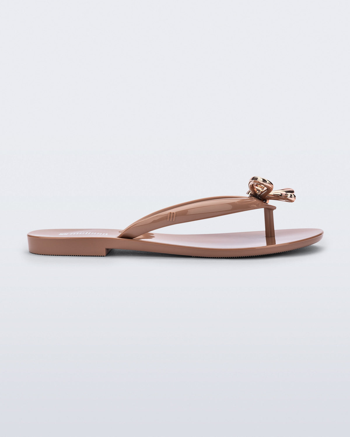 Side view of a brown Harmonic Iris flip flop with rose gold bow