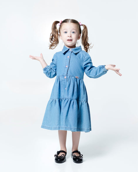 Model in blue dress wearing a pair of black Sweet Love Glam baby ballerinas with bow