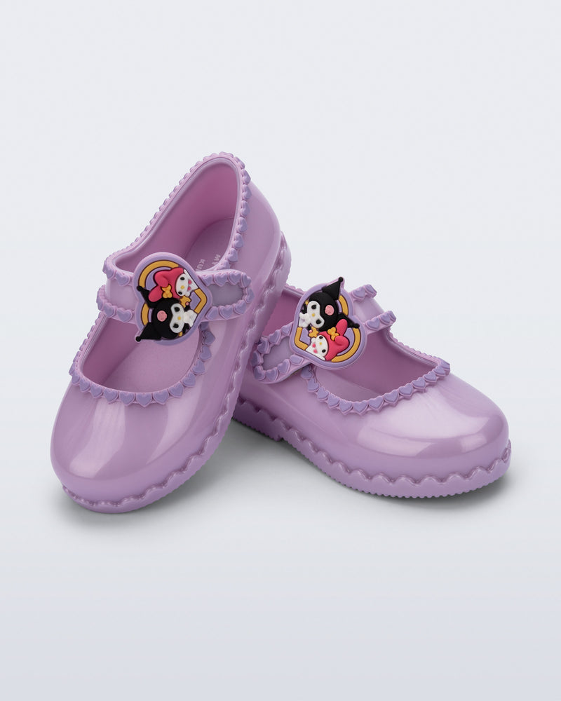 Angled view of a pair of pearly lilac Hip Ballerina + Hello Kitty baby flats