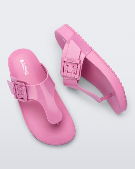 Top and side view of a pair of pink Cozy Flip flops