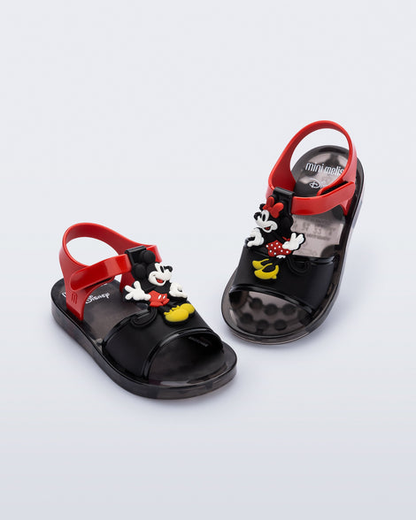 Angled view of a pair of black Play Mickey & Minnie sandals with red straps
