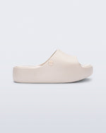 Side view of a beige Free Platform Slide kids sandal