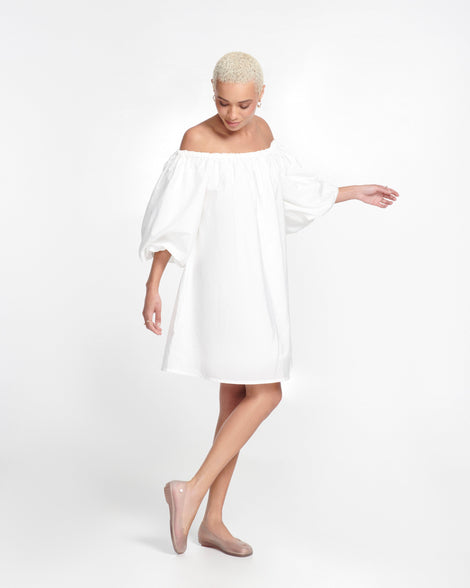 Model in a white dress wearing a pair of clear beige Ultragirl Futura ballerina flats