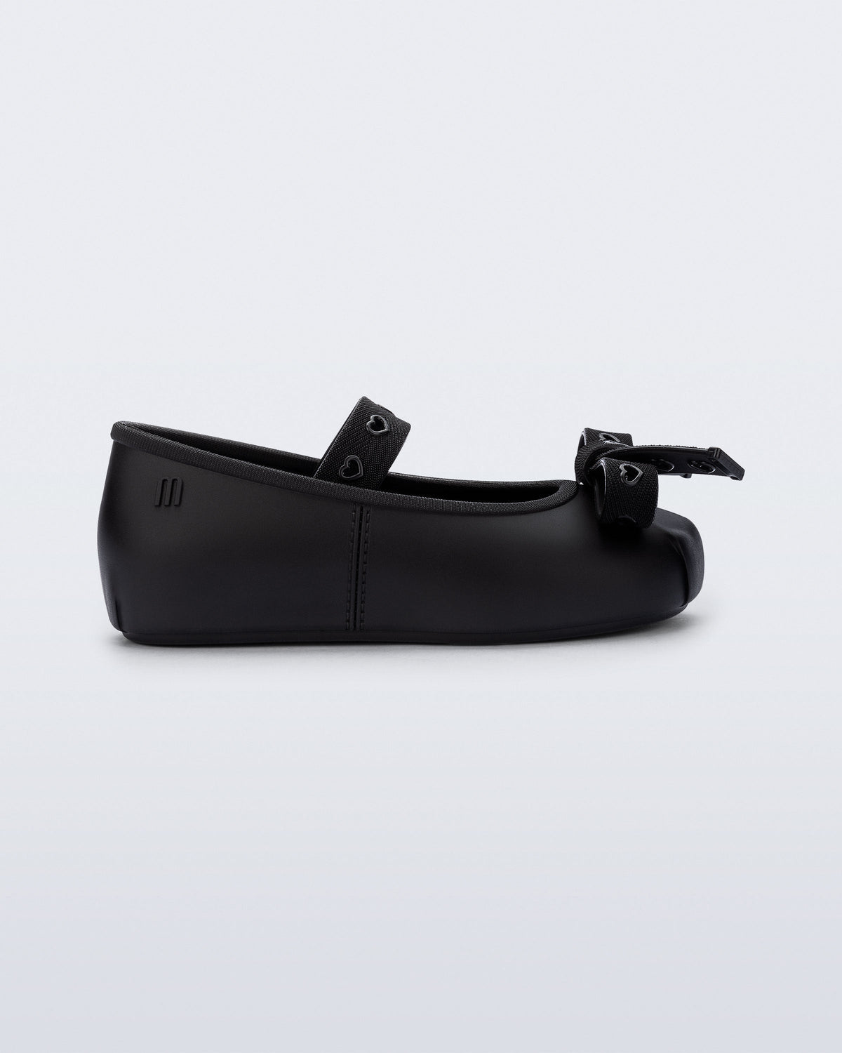 Side view of a black Sophie Crush baby ballerina flat with bow