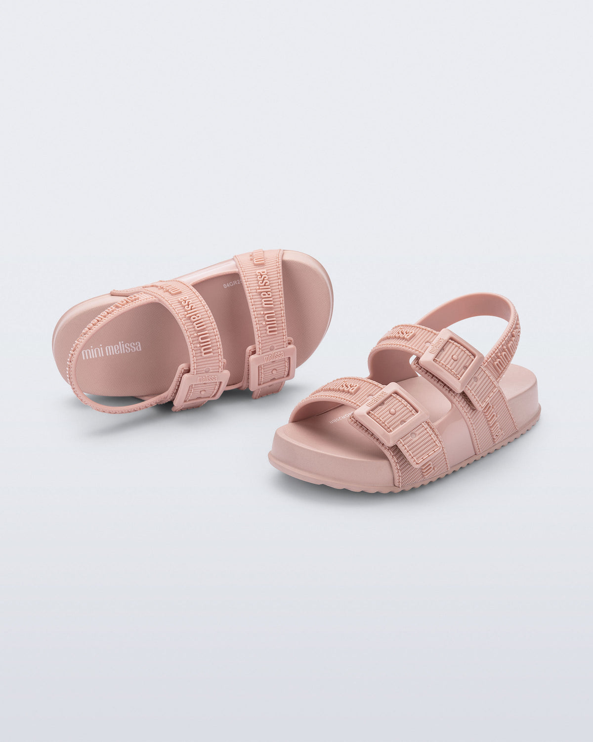 Top and angled view of a pair of pink Cozy M Lover baby sandals