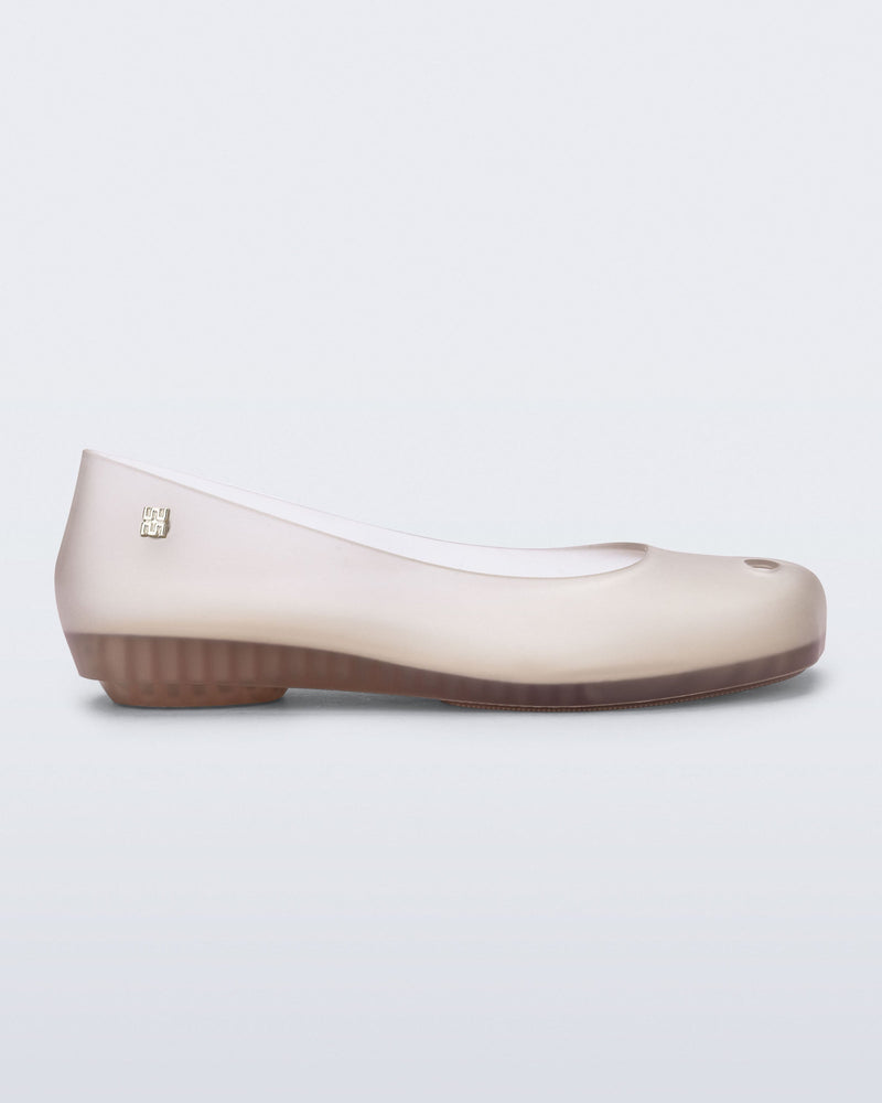Side view of a clear beige Ultragirl Futura ballerina flat
