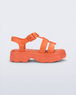 Side view of a orange Ella kids sandal with heel strap