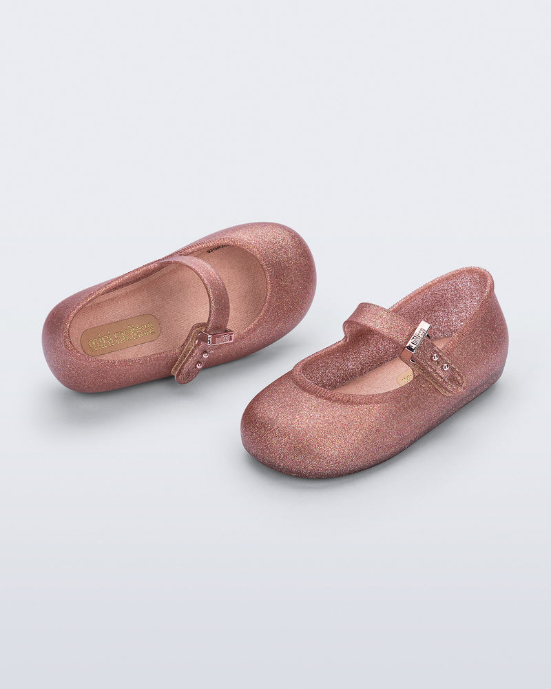 Side and top angled view of a pair of glitter pink Soft Ballerina baby flats