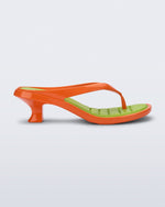 Side view of a orange Flip Flop Kitten Heel with green insole