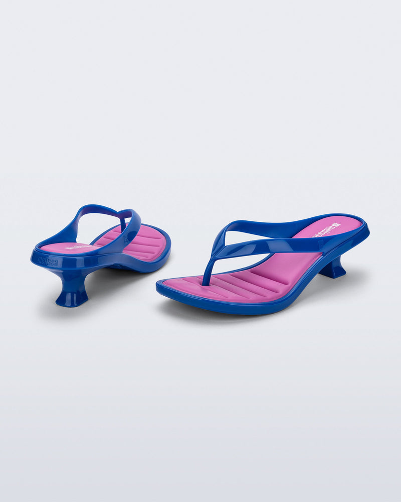 Back and angled view of a pair of blue Flip Flop Kitten Heels with pink insole