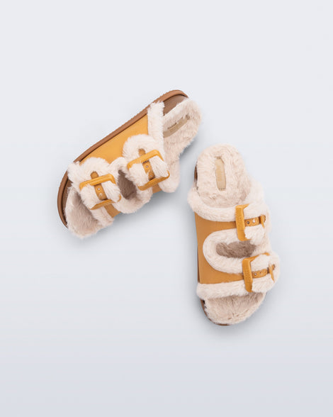 Top and side view of a pair of orange Cozy Warm Slides with beige fuzzy insoles
