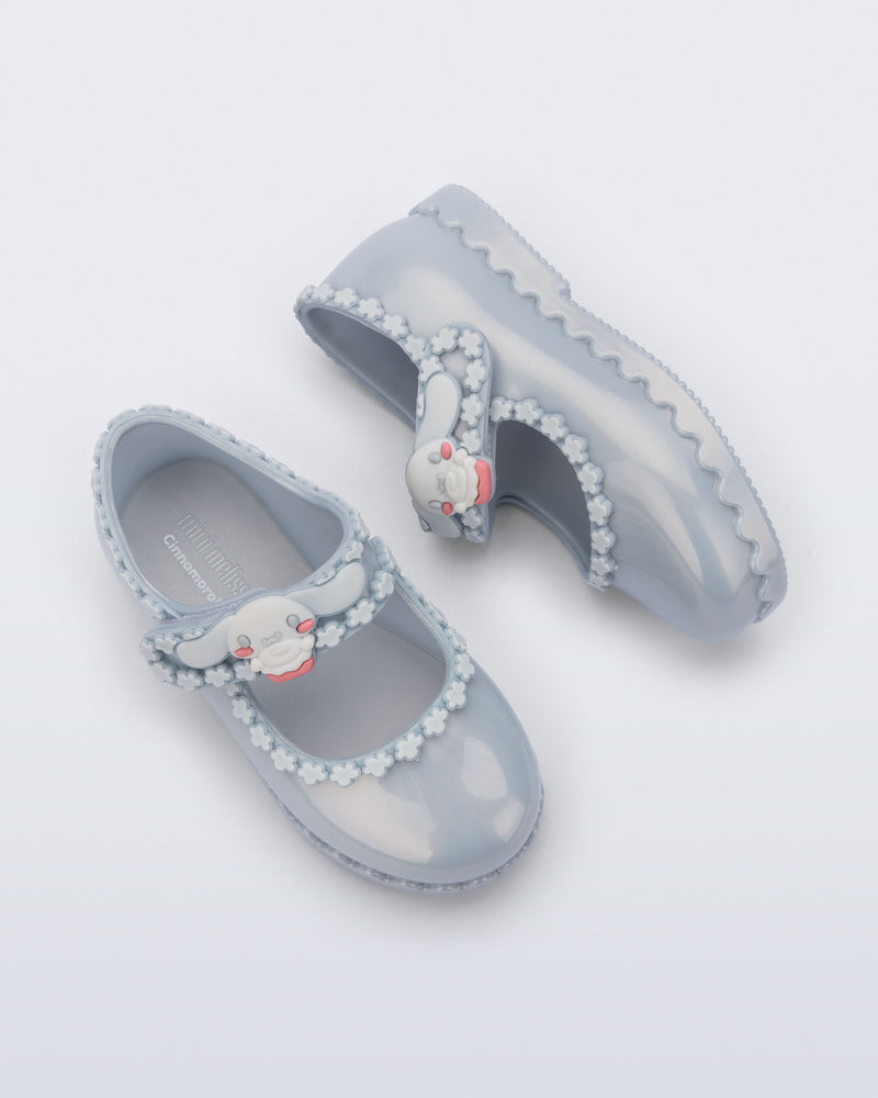 Top and side view of a pair of pearly blue Hip Ballerina + Hello Kitty baby flats
