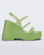 Side view of a green Jessie platform wedge sandal with side buckle ankle strap