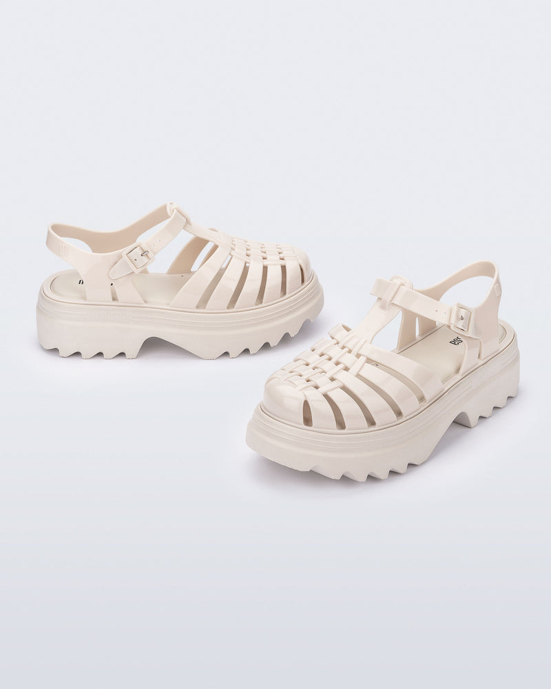 Side and angled view of a pair of beige Possession Platform II sandals.