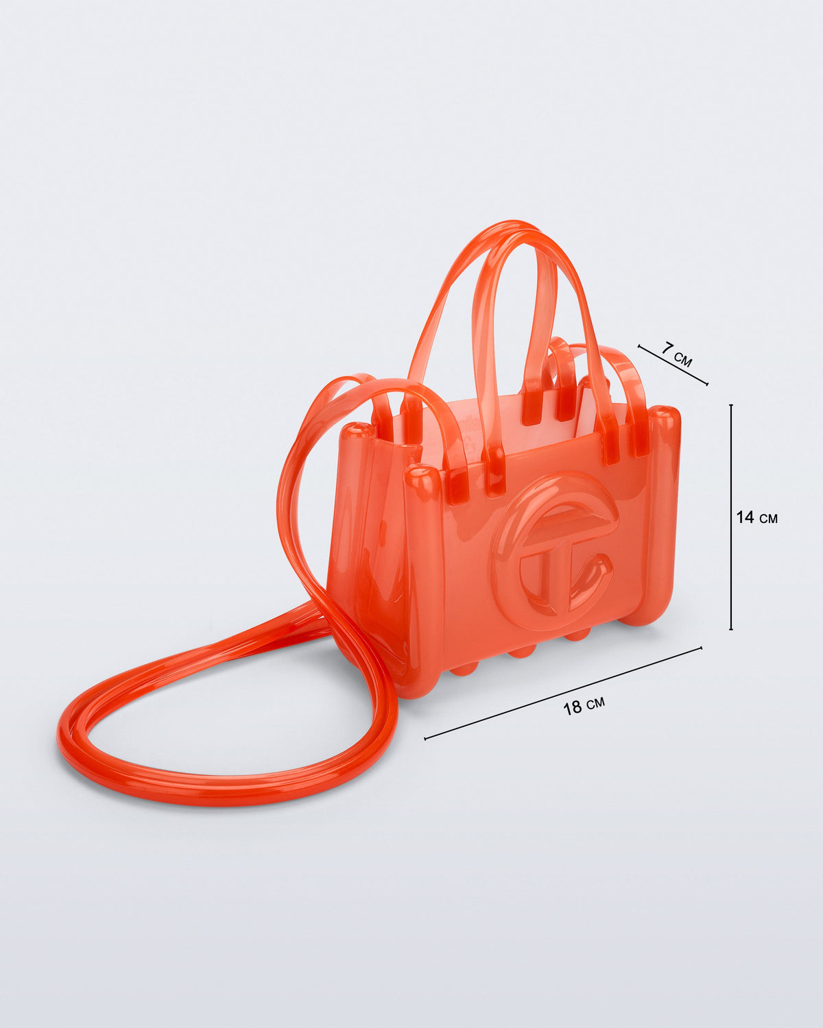 Angled view of the orange Small Jelly Shopper x Telfar bag with dimensions: 18 cm x 7 cm x 14 cm