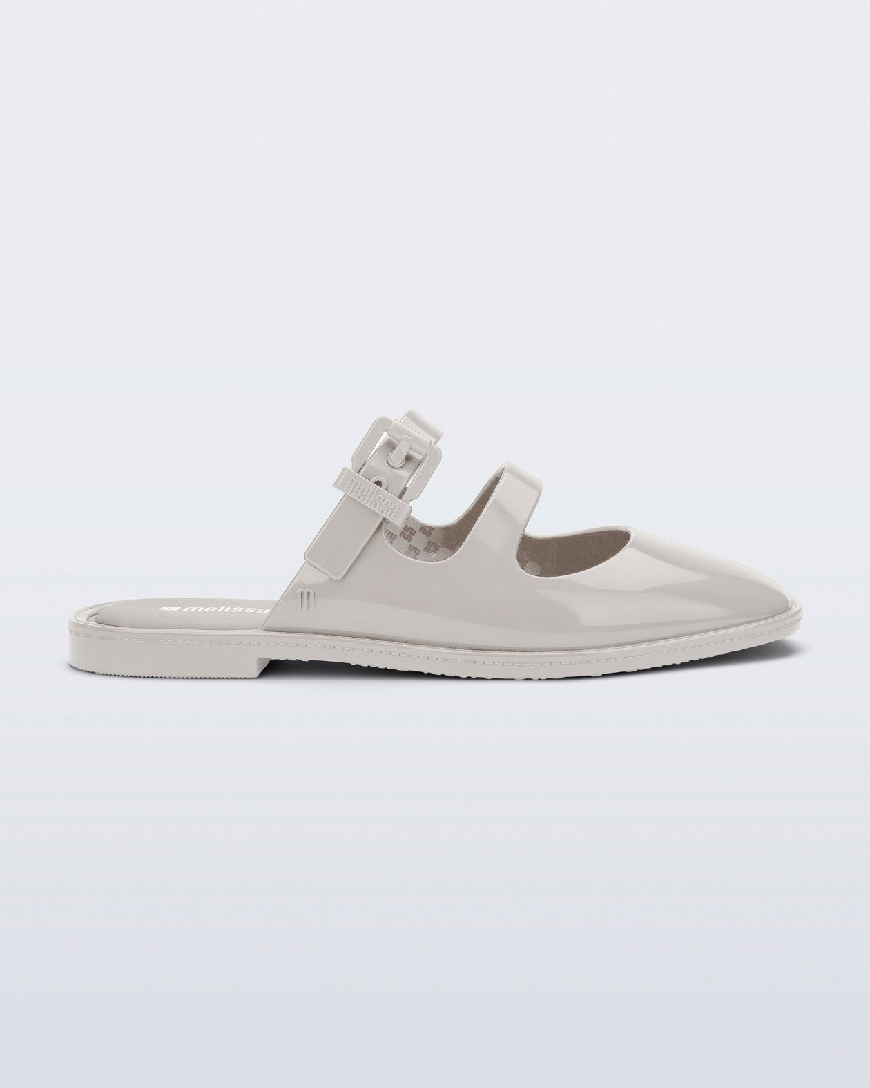 Side view of a beige Anastasia mule slide with upper straps