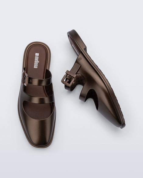 Side and top view of a pair of green Anastasia mule slides