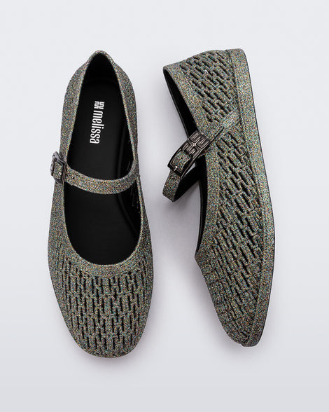 Top and side view of a pair of dark silver glitter Harper flat with strap
