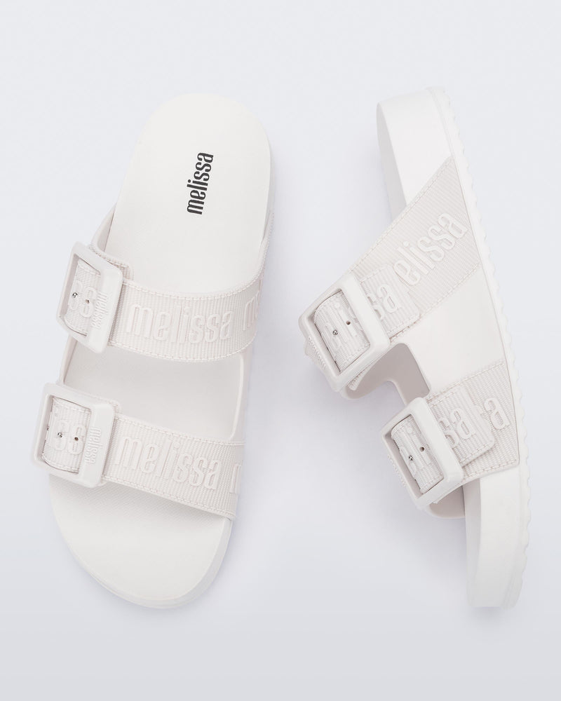 Top and side view of a pair of white Cozy M Love adult slides