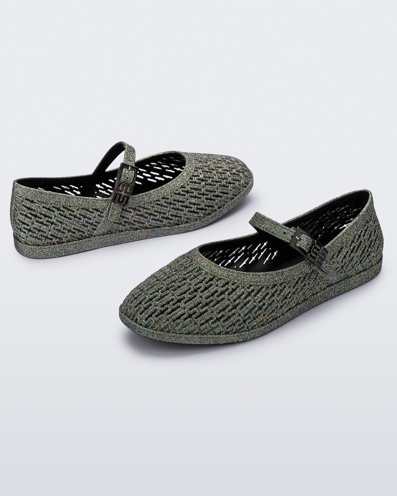 Top and angled view of a pair of dark silver glitter Harper flat with strap