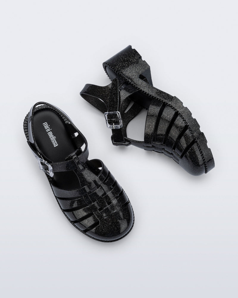 Side and top view of a pair of pearly black Possession Heel kids fisherman sandals