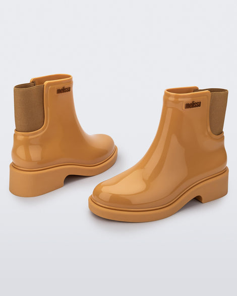 Back and angled view of a pair of caramel Chelsea boots